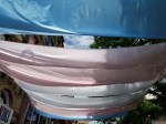 fabric stretched over a walkway in the trans flag colours